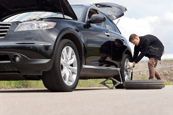 Person Changing Out Flat Tire | Premier Automotive Service in Urbandale, IA